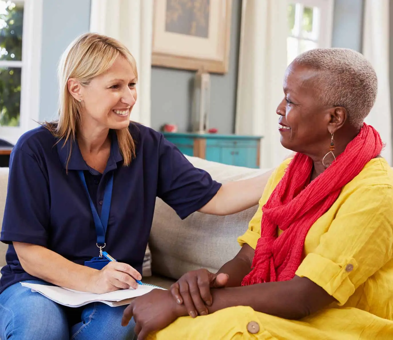 Female caregiver worker visits senior woman at home